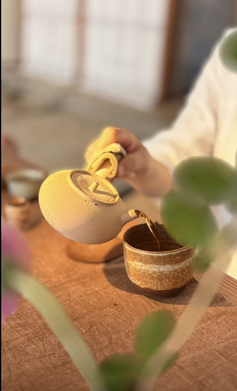 Tea being poured into a handmade cup